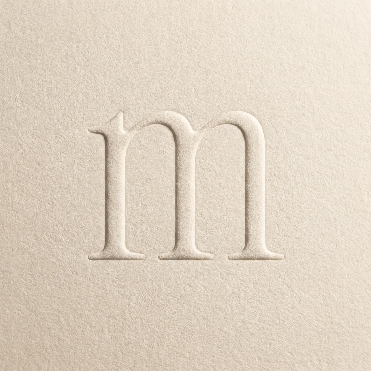 The m blind-embossed in paper